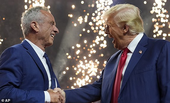 Robert F. Kennedy Jr., who earlier in the day suspended his independent campaign for the White House and endorsedÂ Donald Trump, shakes his hand at a campaign rally in Glendale, Ariz., Aug. 23, 2024. (AP Photo/Evan Vucci)