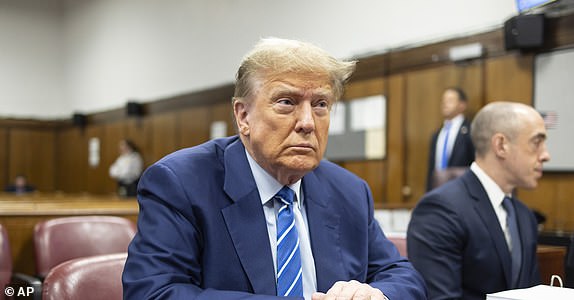 FILE - Former President Donald Trump awaits the start of proceedings on the second day of jury selection at Manhattan criminal court, April 16, 2024, in New York.  Manhattan prosecutors are balking at Donald Trump efforts to delay post-trial decisions in his New York hush money criminal case as he seeks to have a federal court intervene and potentially overturn his felony conviction. They lodged their objections in a letter Tuesday to the trial judge but said they could be OK with postponing the ex-president's Sept. 18 sentencing.  (Justin Lane/Pool Photo via AP)