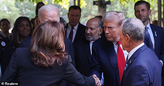 Republican presidential nominee and former U.S. President Donald Trump shakes hands with Democratic presidential nominee and Vice President Kamala Harris on the day of a ceremony marking the 23rd anniversary of the September 11, 2001 attacks on the World Trade Center at the 9/11 Memorial and Museum in the Manhattan borough of New York City, U.S., September 11, 2024. REUTERS/Mike Segar