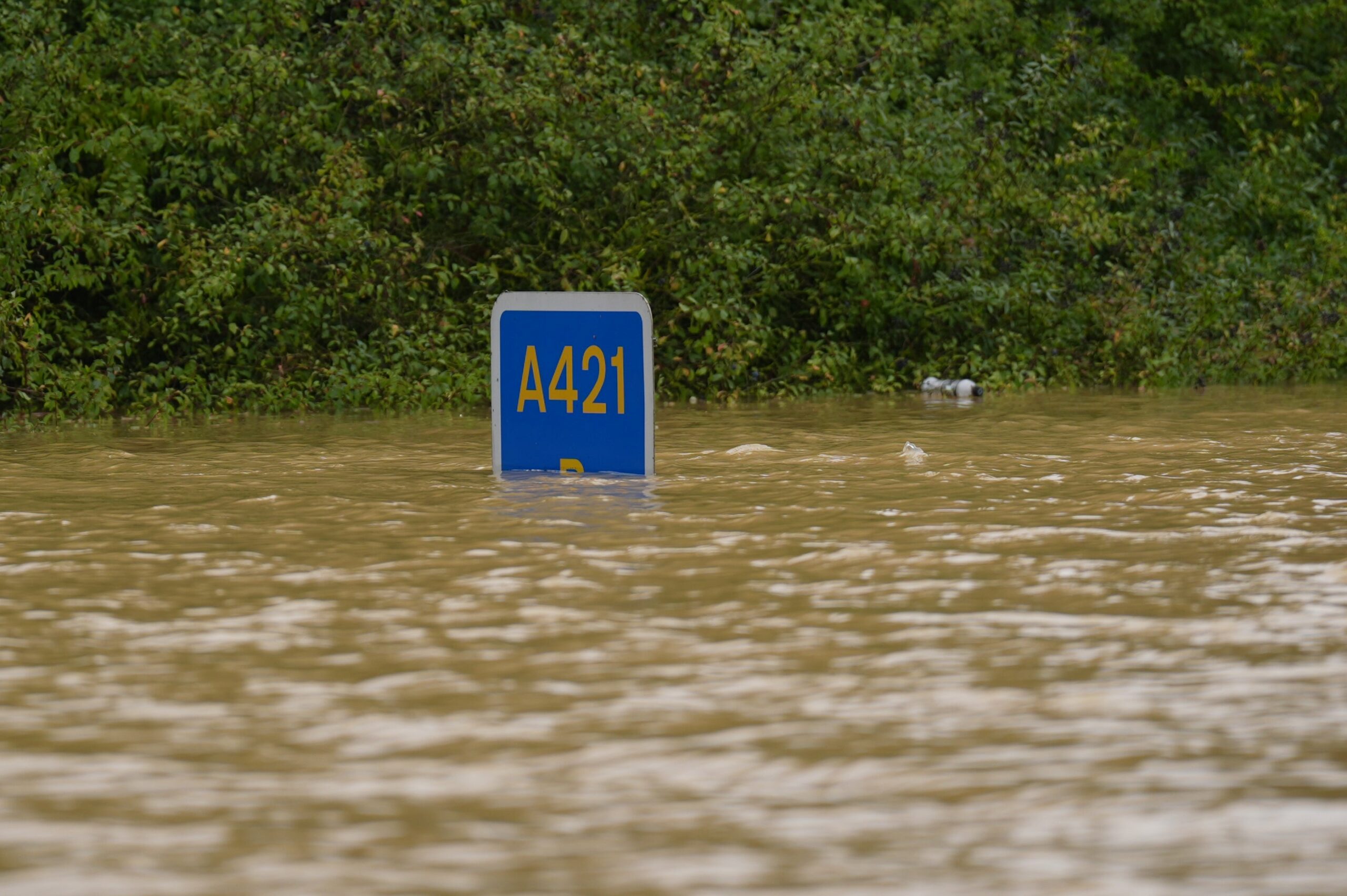 A road sign submerged in flood water on the A421 in Marston Moretaine, Bedfordshire (Joe Giddens/PA)