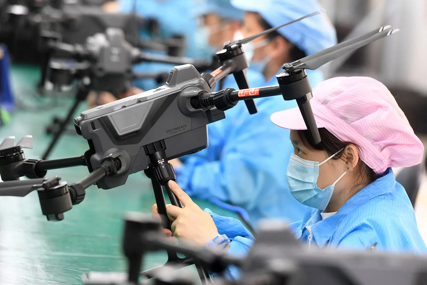 Workers produce drones at a factory in Wuhan, China.