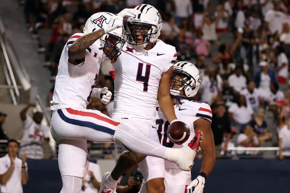 Wide receiver Tetairoa McMillan (4) of the Arizona Wildcats celebrates with wide receiver Jeremiah Patterson (2) after scoring a touchdown during the third quarter against the New Mexico Lobos at Arizona Stadium on Aug. 31, 2024, in Tucson.