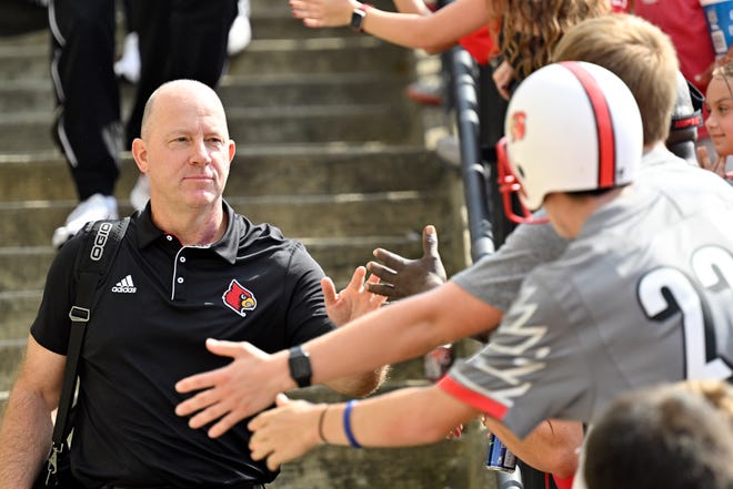 Sep 21, 2024; Louisville, Kentucky, USA; Louisville Cardinals head coach Jeff Brohm greets fans during the Card March before a game against the Georgia Tech Yellow Jackets at L&N Federal Credit Union Stadium. Mandatory Credit: Jamie Rhodes-Imagn Images