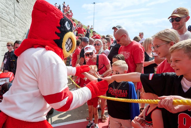 Sep 21, 2024; Louisville, Kentucky, USA; The Louisville Cardinals mascot greets fans before the Card March prior to a game against the Georgia Tech Yellow Jackets at L&N Federal Credit Union Stadium. Mandatory Credit: Jamie Rhodes-Imagn Images