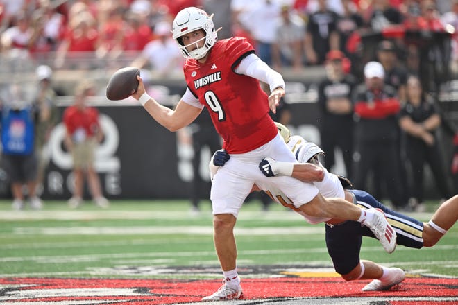 Sep 21, 2024; Louisville, Kentucky, USA; Louisville Cardinals quarterback Tyler Shough (9) looks to pass while being tackled by Georgia Tech Yellow Jackets linebacker Kyle Efford (44) during the first quarter at L&N Federal Credit Union Stadium. Mandatory Credit: Jamie Rhodes-Imagn Images