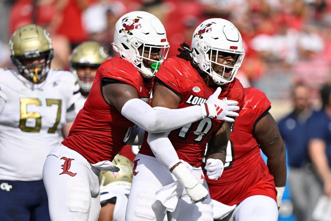 Sep 21, 2024; Louisville, Kentucky, USA; Louisville Cardinals defensive lineman Tramel Logan (19) celebrates a defensive stop against the Georgia Tech Yellow Jackets during the first half at L&N Federal Credit Union Stadium. Mandatory Credit: Jamie Rhodes-Imagn Images