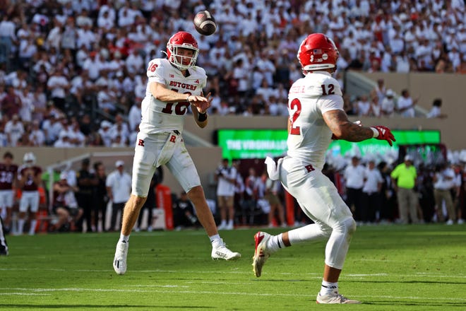 Sep 21, 2024; Blacksburg, Virginia, USA; Rutgers Scarlet Knights quarterback Athan Kaliakmanis (16) throws a pass to tight end Kenny Fletcher (12) during the second quarter against the Virginia Tech Hokies at Lane Stadium. Mandatory Credit: Peter Casey-Imagn Images