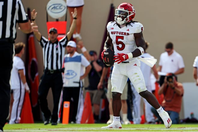 Sep 21, 2024; Blacksburg, Virginia, USA; Rutgers Scarlet Knights running back Kyle Monangai (5) celebrates after scoring a touchdown during the first quarter against the Virginia Tech Hokies at Lane Stadium. Mandatory Credit: Peter Casey-Imagn Images