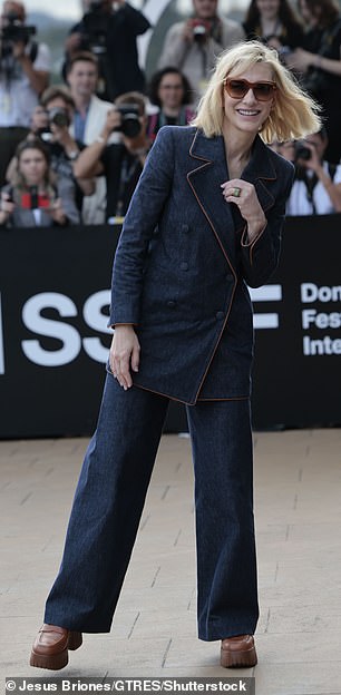 The 55-year-old actress put on a chic display in a denim, double breasted blazer with light brown, contrasting trim and a pair of matching, straight-leg jeans