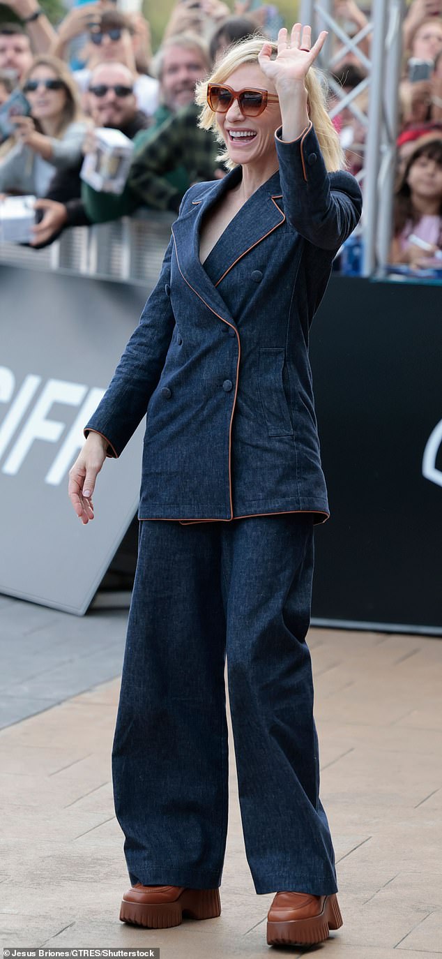 To match the subtle details of her top, she sported brown platform leather mules and a pair of oversize, tinted sunglasses