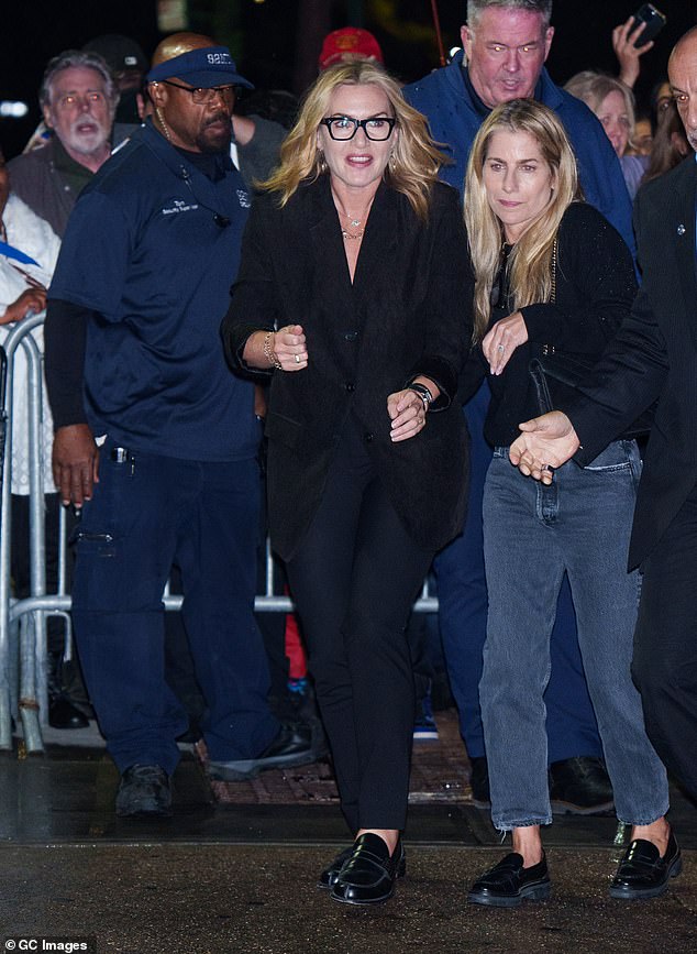 Kate complemented the oversized jacket with smart navy trousers and black loafers. She accessorised with black square framed glasses and gold earrings