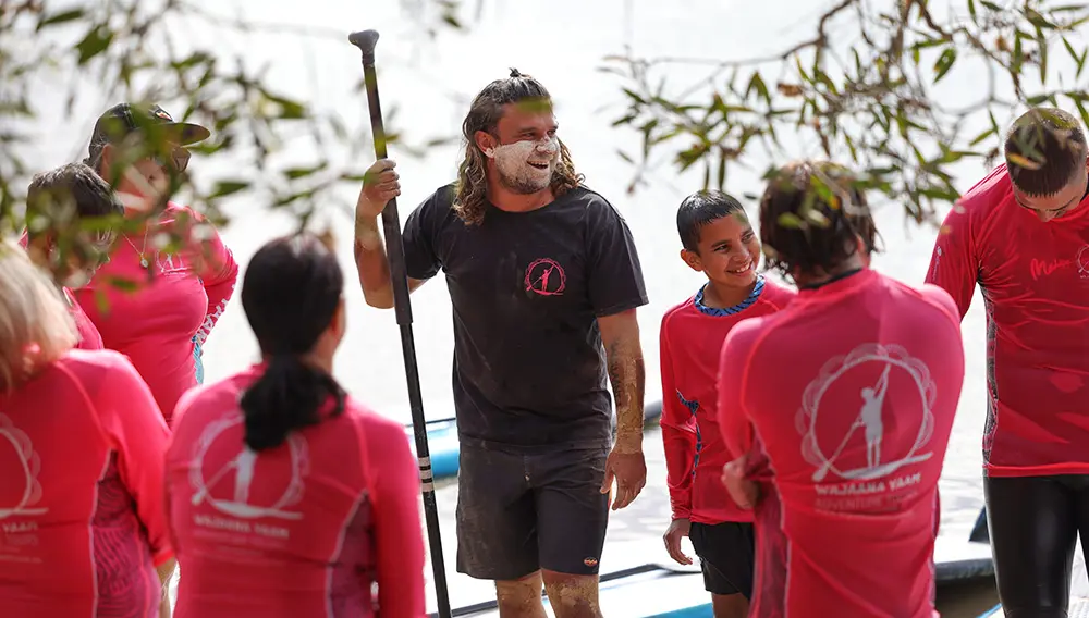 Paddle with the direct descendants of the world’s first stand up paddlers and connect to land and sea through stories and language and collect and taste seasonal bush tucker with Wajaana Yaam Gumbaynggirr Adventure Tours, Coffs Harbour. Image: Destination NSW