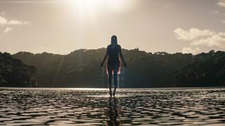 A woman floating above a lake in 