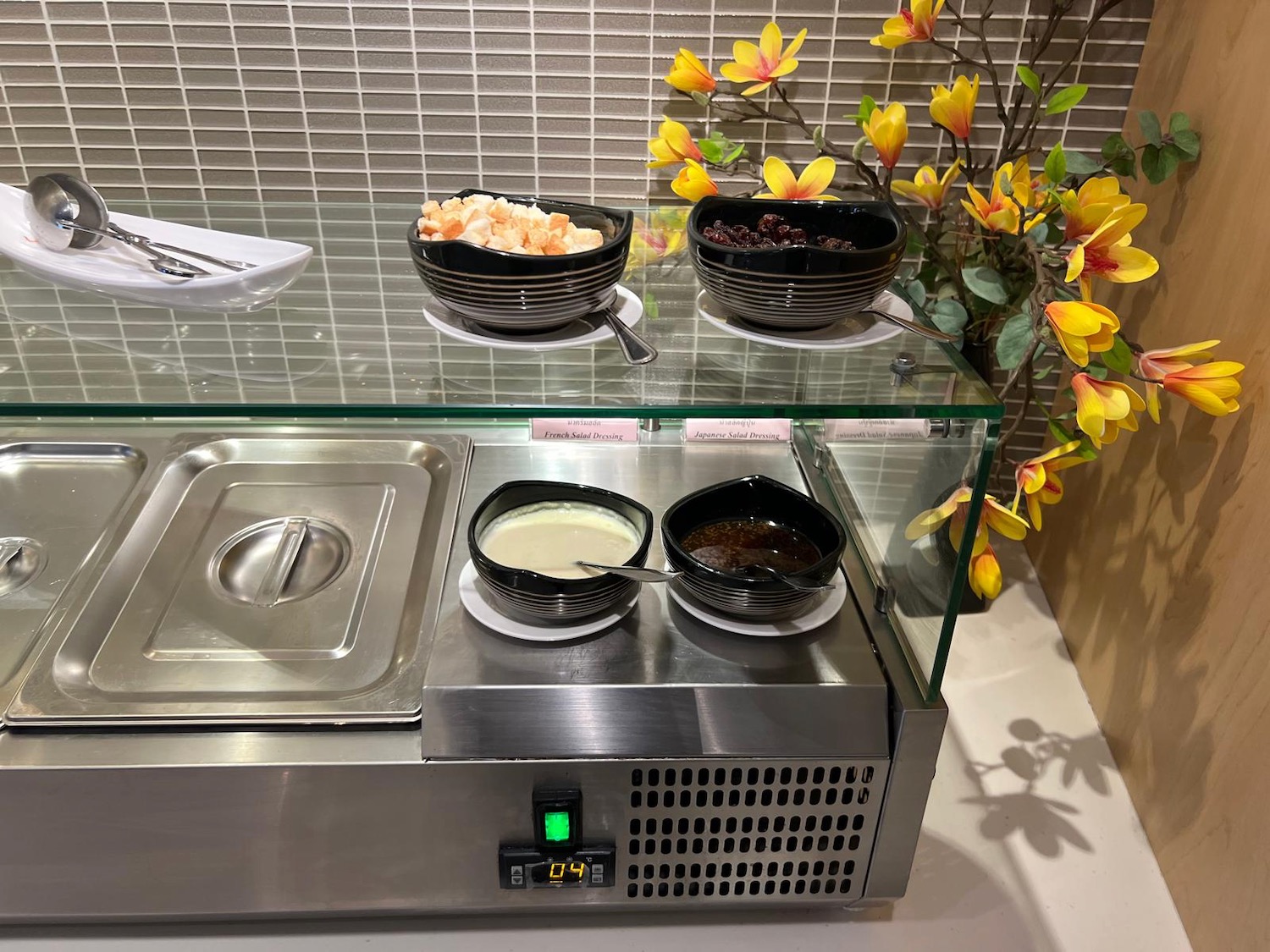 a buffet with bowls of food on a counter