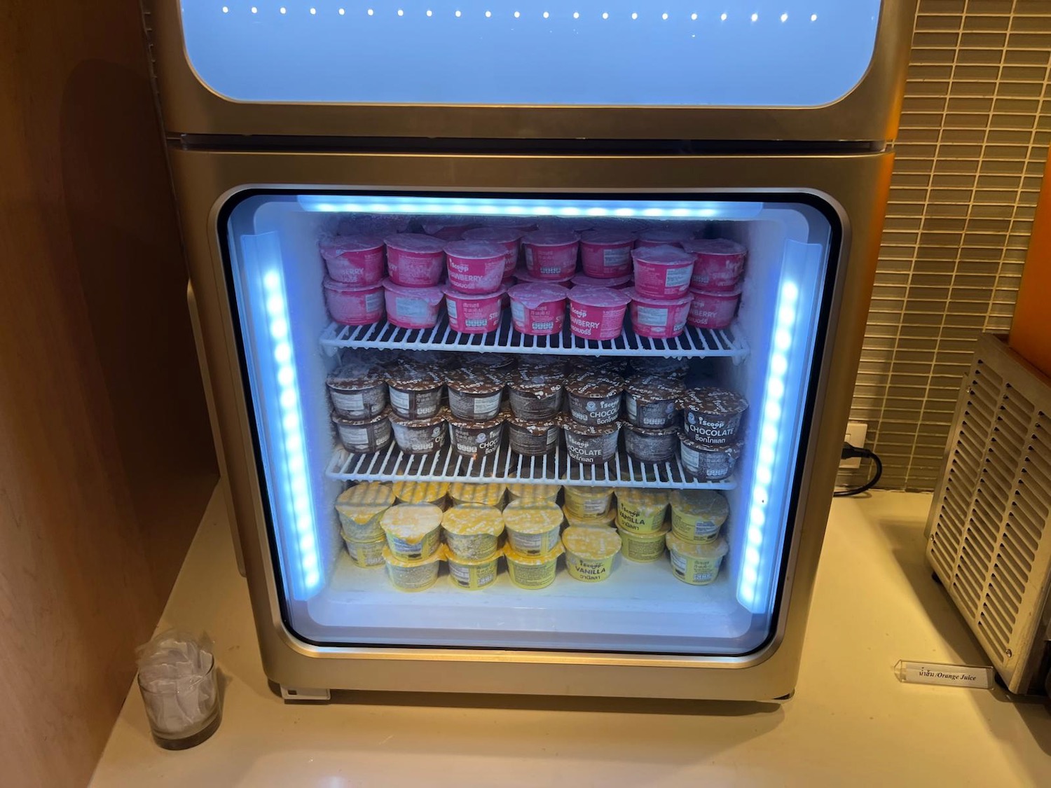 a refrigerator with ice cream in it