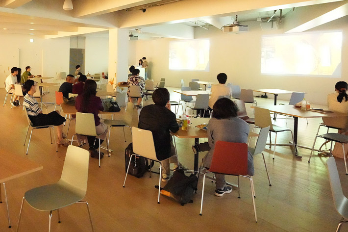 Participants watching film in Taki Plaza's Event Space