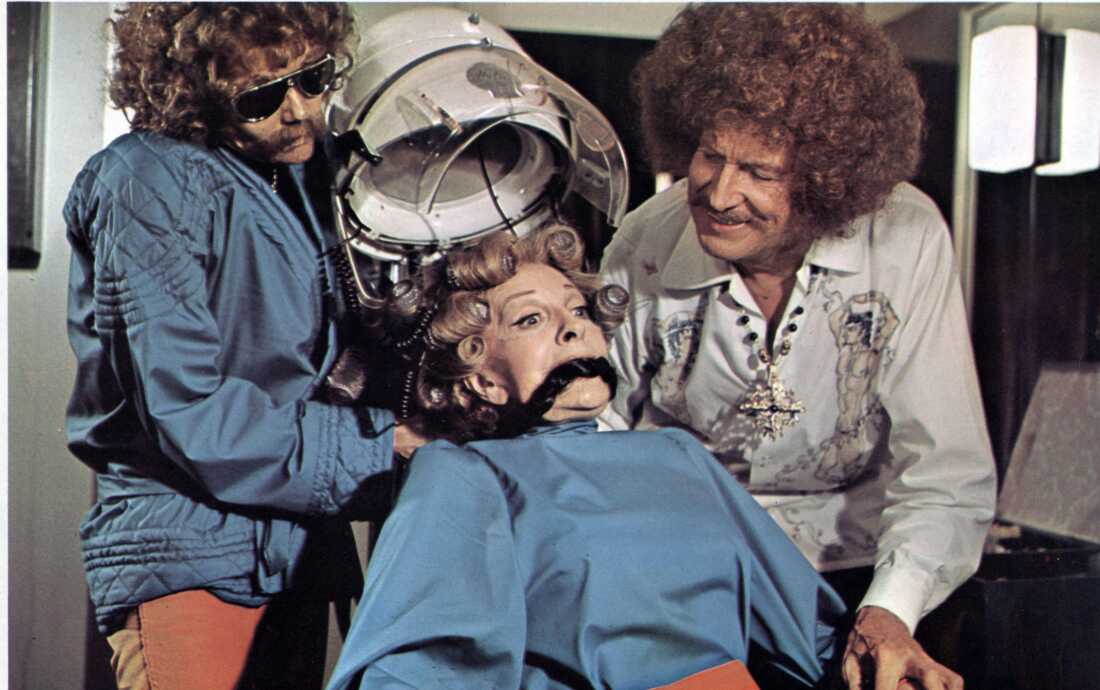 In Theater of Blood, Edward Lionheart (right, played by Vincent Price), assisted by his daughter Edwina kills the critic Chloe Moon (Coral Browne, center) by disguising as a hairdresser and electrocuting her with hair curlers, inspired by the burning of Joan of Arc in Henry VI, Part I.