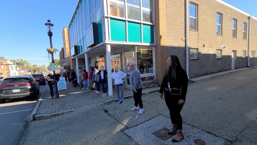 people lined up along a sidewalk