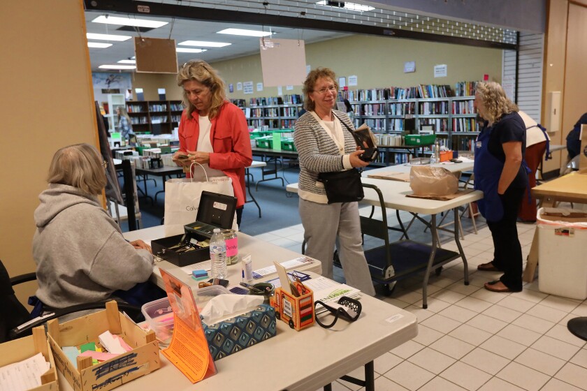 People check out with their purchases Wednesday, Oct. 23, 2024, during the Friends of the Brainerd Public Library Book Sale at the Westgate Mall. The book sale wraps up 6 p.m. on Thursday.