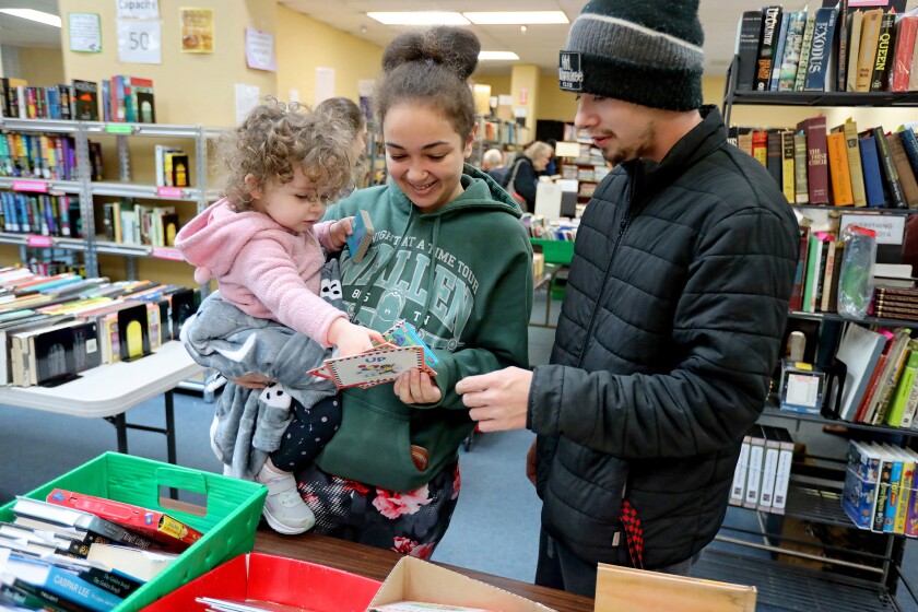 Eliza Carter, left, Megan Carter and Brady Kilchesky browse through books Wednesday, Oct. 23, 2024, during the Friends of the Brainerd Public Library Book Sale at the Westgate Mall. The book sale wraps up 6 p.m. on Thursday.