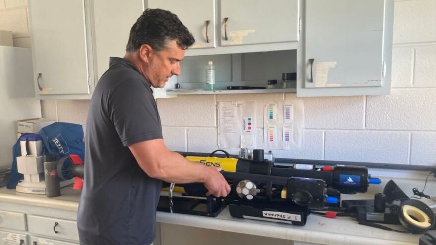 NOAA National Ocean Service Research Ecologist Dr. Chris Taylor works with an autonomous underwater vehicle – a drone, like you may have seeing flying overhead, but made for use in the water.