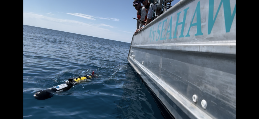 An AUV being deployed by a NOAA researcher.