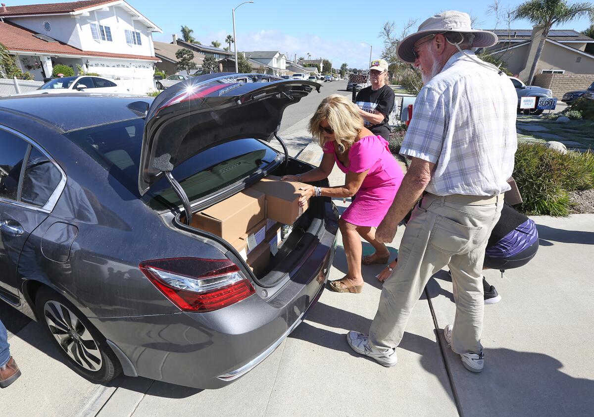 Volunteers help load boxes of signed, verified petitions, to be delivered to City Hall on Monday.