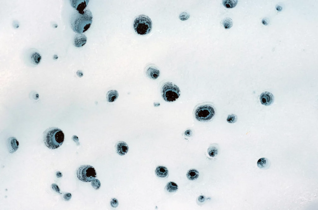 Image of holes, captured on Alaska’s Matanuska Glacier, formed by cryoconite 