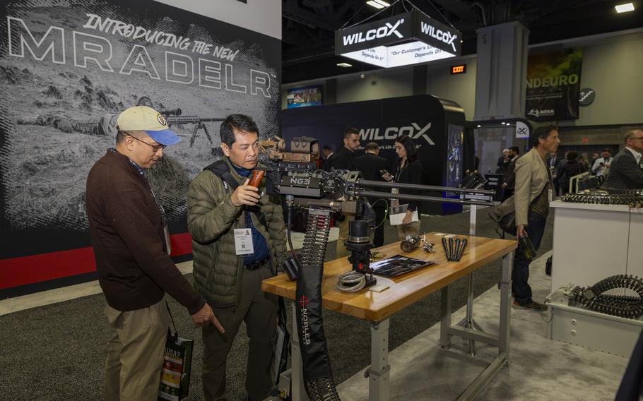 Participants sight in an automatic rifle