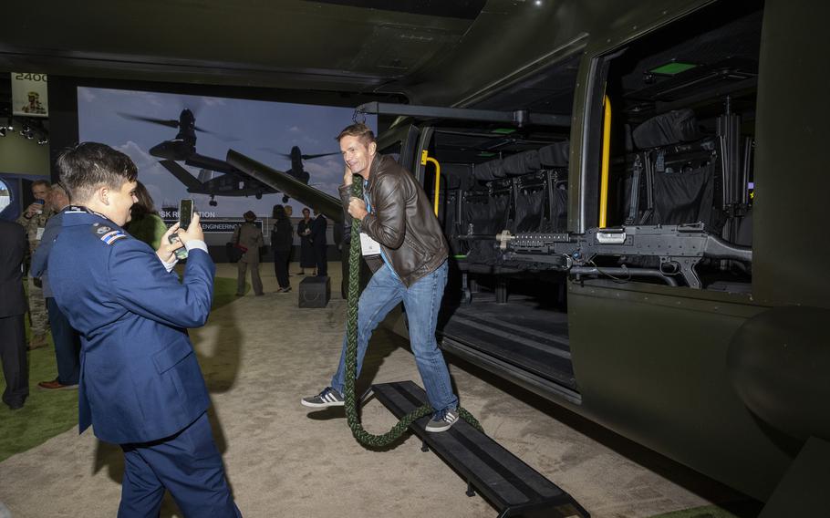 Attendees take photos around an Osprey