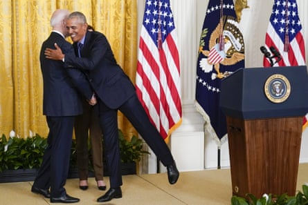 Joe Biden hugs Barack Obama on stage