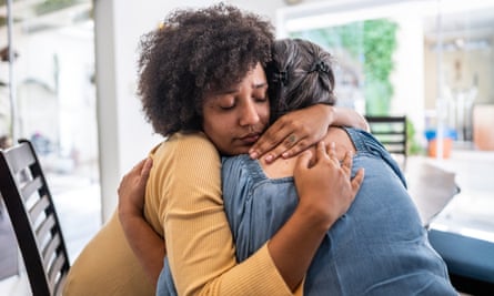 Two women hugging each other tightly