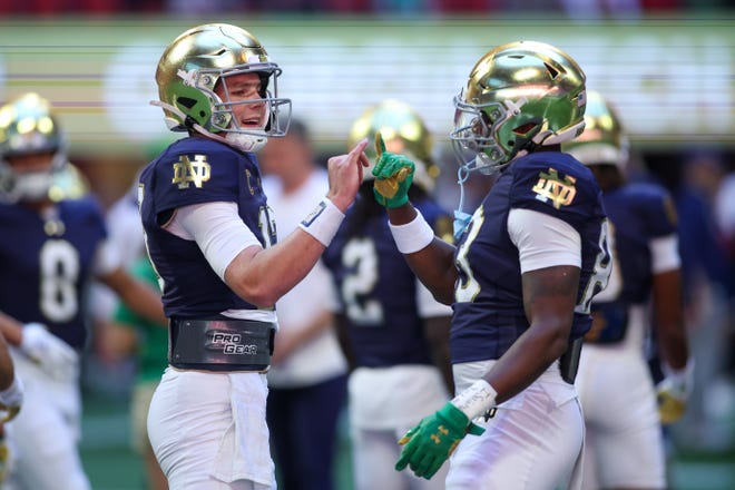 Oct 19, 2024; Atlanta, Georgia, USA; Notre Dame Fighting Irish quarterback Riley Leonard (13) talks with wide receiver Jayden Thomas (83) before a game against the Georgia Tech Yellow Jackets at Mercedes-Benz Stadium. Mandatory Credit: Brett Davis-Imagn Images