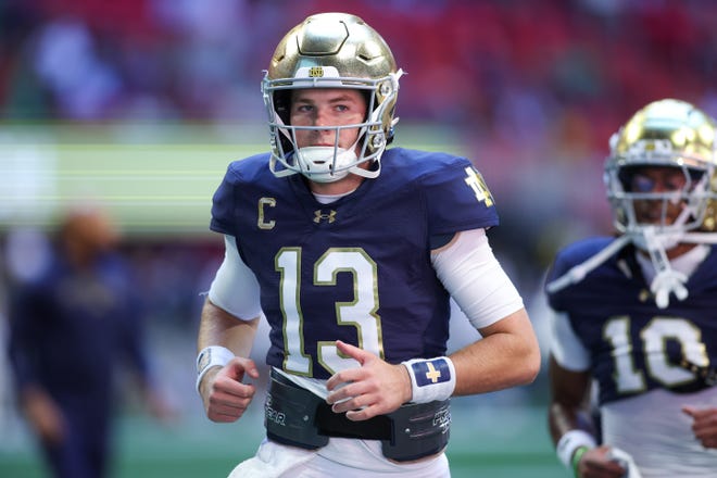 Oct 19, 2024; Atlanta, Georgia, USA; Notre Dame Fighting Irish quarterback Riley Leonard (13) runs off the field before a game against the Georgia Tech Yellow Jackets at Mercedes-Benz Stadium. Mandatory Credit: Brett Davis-Imagn Images