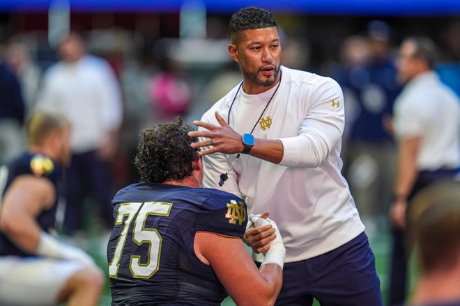 Oct 19, 2024; Atlanta, Georgia, USA; Notre Dame Fighting Irish head coach Marcus Freeman greets players before the game against the Georgia Tech Yellow Jackets at Mercedes-Benz Stadium. Mandatory Credit: Dale Zanine-Imagn Images