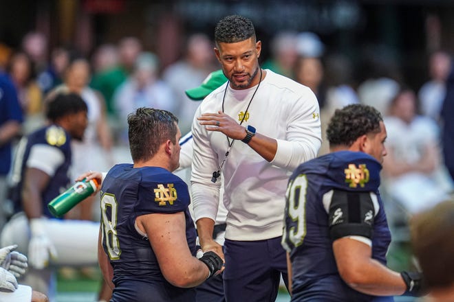 Oct 19, 2024; Atlanta, Georgia, USA; Notre Dame Fighting Irish head coach Marcus Freeman greets players before the game against the Georgia Tech Yellow Jackets at Mercedes-Benz Stadium. Mandatory Credit: Dale Zanine-Imagn Images