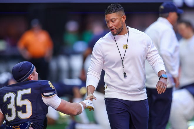 Oct 19, 2024; Atlanta, Georgia, USA; Notre Dame Fighting Irish head coach Marcus Freeman talks to running back Jake Tafelski (35) before a game against the Georgia Tech Yellow Jackets at Mercedes-Benz Stadium. Mandatory Credit: Brett Davis-Imagn Images