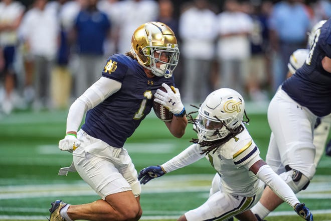 Oct 19, 2024; Atlanta, Georgia, USA; Notre Dame Fighting Irish wide receiver Jaden Greathouse (1) runs against Georgia Tech Yellow Jackets defensive back LaMiles Brooks (1) during the first quarter at Mercedes-Benz Stadium. Mandatory Credit: Dale Zanine-Imagn Images