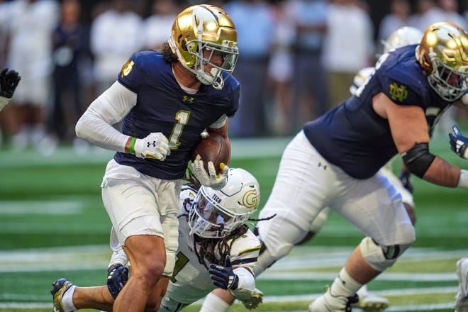 Oct 19, 2024; Atlanta, Georgia, USA; Notre Dame Fighting Irish wide receiver Jaden Greathouse (1) runs against Georgia Tech Yellow Jackets defensive back LaMiles Brooks (1) during the first quarter at Mercedes-Benz Stadium. Mandatory Credit: Dale Zanine-Imagn Images