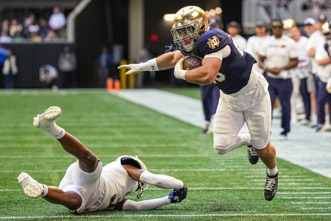 Oct 19, 2024; Atlanta, Georgia, USA; Notre Dame Fighting Irish running back Aneyas Williams (20) runs against Georgia Tech Yellow Jackets defensive back Ahmari Harvey (3) during the first half at Mercedes-Benz Stadium. Mandatory Credit: Dale Zanine-Imagn Images