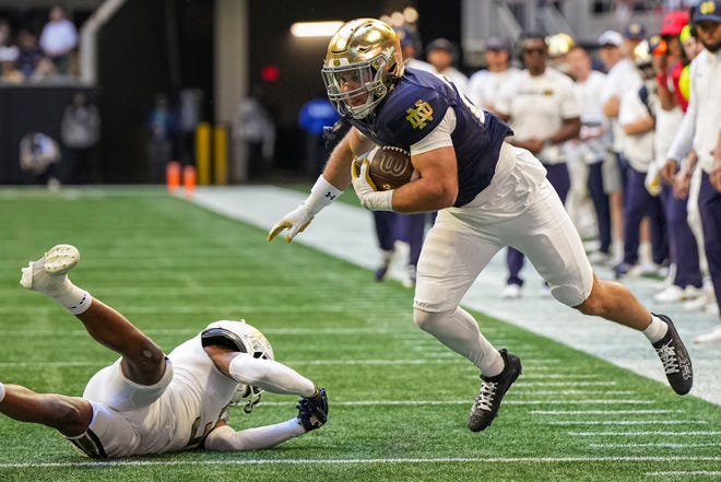 Oct 19, 2024; Atlanta, Georgia, USA; Notre Dame Fighting Irish running back Aneyas Williams (20) runs against Georgia Tech Yellow Jackets defensive back Ahmari Harvey (3) during the first half at Mercedes-Benz Stadium. Mandatory Credit: Dale Zanine-Imagn Images