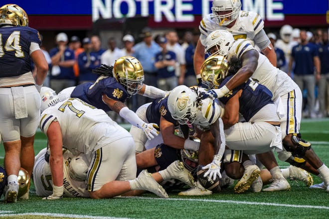 Oct 19, 2024; Atlanta, Georgia, USA; Georgia Tech Yellow Jackets running back Jamal Haynes (11) fumbles but recovers for a touchdown against the Notre Dame Fighting Irish during the first half at Mercedes-Benz Stadium. Mandatory Credit: Dale Zanine-Imagn Images