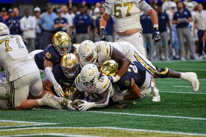 Oct 19, 2024; Atlanta, Georgia, USA; Georgia Tech Yellow Jackets running back Jamal Haynes (11) fumbles but recovers for a touchdown against the Notre Dame Fighting Irish during the first half at Mercedes-Benz Stadium. Mandatory Credit: Dale Zanine-Imagn Images