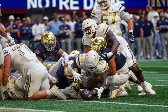 Oct 19, 2024; Atlanta, Georgia, USA; Georgia Tech Yellow Jackets running back Jamal Haynes (11) fumbles but recovers for a touchdown against the Notre Dame Fighting Irish during the first half at Mercedes-Benz Stadium. Mandatory Credit: Dale Zanine-Imagn Images