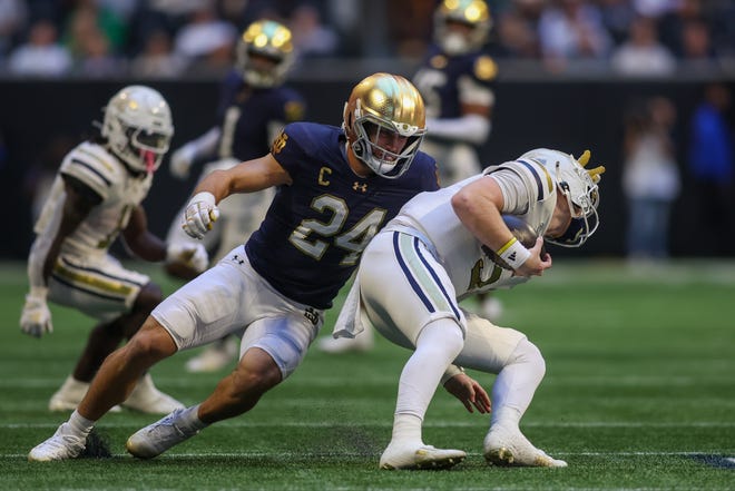 Oct 19, 2024; Atlanta, Georgia, USA; Notre Dame Fighting Irish linebacker Jack Kiser (24) tackles Georgia Tech Yellow Jackets quarterback Zach Pyron (5) in the second quarter at Mercedes-Benz Stadium. Mandatory Credit: Brett Davis-Imagn Images