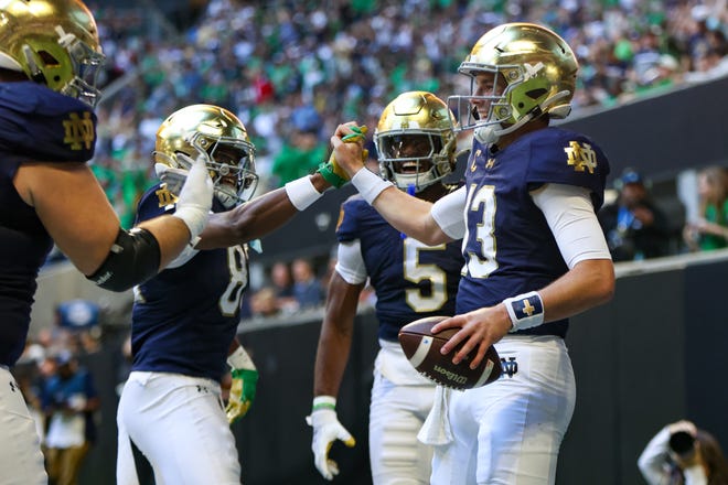 Oct 19, 2024; Atlanta, Georgia, USA; Notre Dame Fighting Irish quarterback Riley Leonard (13) celebrates with wide receiver Jayden Thomas (83) after a touchdown against the Georgia Tech Yellow Jackets in the second quarter at Mercedes-Benz Stadium. Mandatory Credit: Brett Davis-Imagn Images