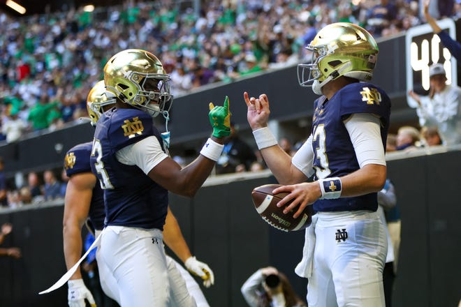 Oct 19, 2024; Atlanta, Georgia, USA; Notre Dame Fighting Irish quarterback Riley Leonard (13) celebrates with wide receiver Jayden Thomas (83) after a touchdown against the Georgia Tech Yellow Jackets in the second quarter at Mercedes-Benz Stadium. Mandatory Credit: Brett Davis-Imagn Images