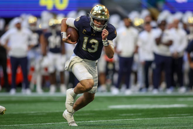 Oct 19, 2024; Atlanta, Georgia, USA; Notre Dame Fighting Irish quarterback Riley Leonard (13) runs the ball for a touchdown against the Georgia Tech Yellow Jackets in the second quarter at Mercedes-Benz Stadium. Mandatory Credit: Brett Davis-Imagn Images