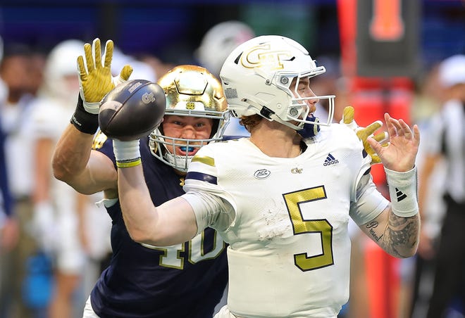 ATLANTA, GEORGIA - OCTOBER 19: Zach Pyron #5 of the Georgia Tech Yellow Jackets looks to pass as he is pressured by Joshua Burnham #40 of the Notre Dame Fighting Irish during the second quarter at Bobby Dodd Stadium on October 19, 2024 in Atlanta, Georgia. (Photo by Kevin C. Cox/Getty Images)