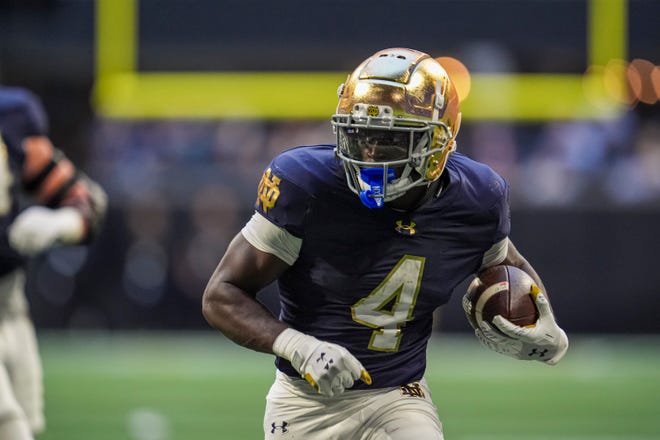 Oct 19, 2024; Atlanta, Georgia, USA; Notre Dame Fighting Irish running back Jeremiyah Love (4) runs against the Georgia Tech Yellow Jackets during the second half at Mercedes-Benz Stadium. Mandatory Credit: Dale Zanine-Imagn Images